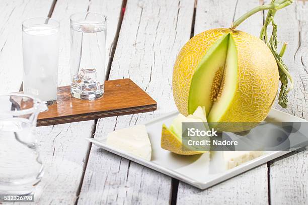 Turkish Raki Ouzo With Melon On Wooden Table Stock Photo - Download Image Now - Alcohol - Drink, Appetizer, Backgrounds