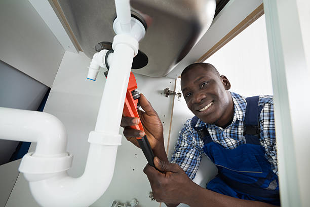 Handyman Repairing Sink Pipe Young African Handyman Repairing Sink Pipe With Worktool Plumber stock pictures, royalty-free photos & images