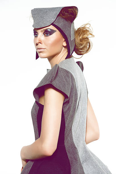 Blond hair model in futuristic clothes studio shot 