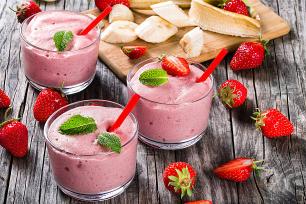 istock Strawberry Banana Smoothies Cups on an old rustic wooden table 532331174