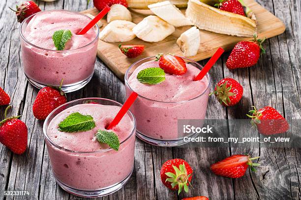 Strawberry Banana Smoothies Cups On An Old Rustic Wooden Table Stock Photo - Download Image Now