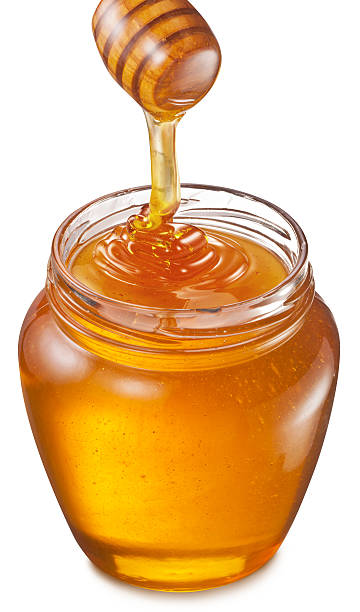 istock Honey flowing into glass jar. 532331905