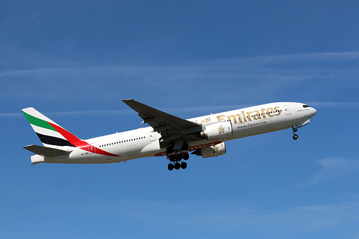 Prague, Czech Republic  - July 23, 2012: Boeing 777 Emirates climbs after take off from PRG Airport in Czech Republic.