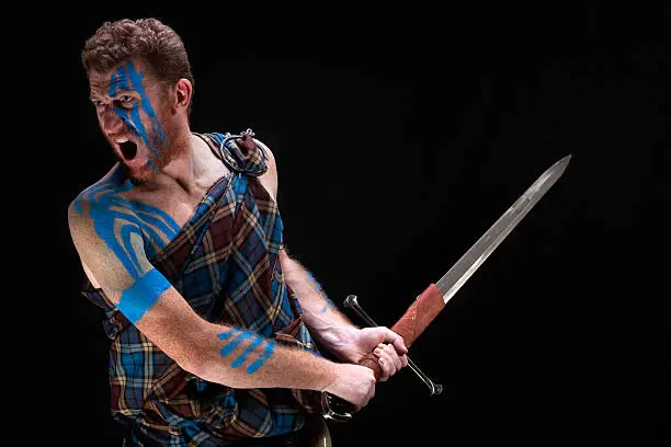 Strong young man as Scottish highlander tribe warrior