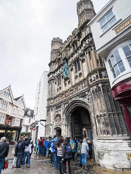 Сanterbury, UK - January 13, 2015: Students gather outside Canterbury cathedral entrance. In 1170 Archbishop Thomas Becket was murdered in the Cathedral and ever since, the Cathedral has attracted thousands of pilgrims and tourists.