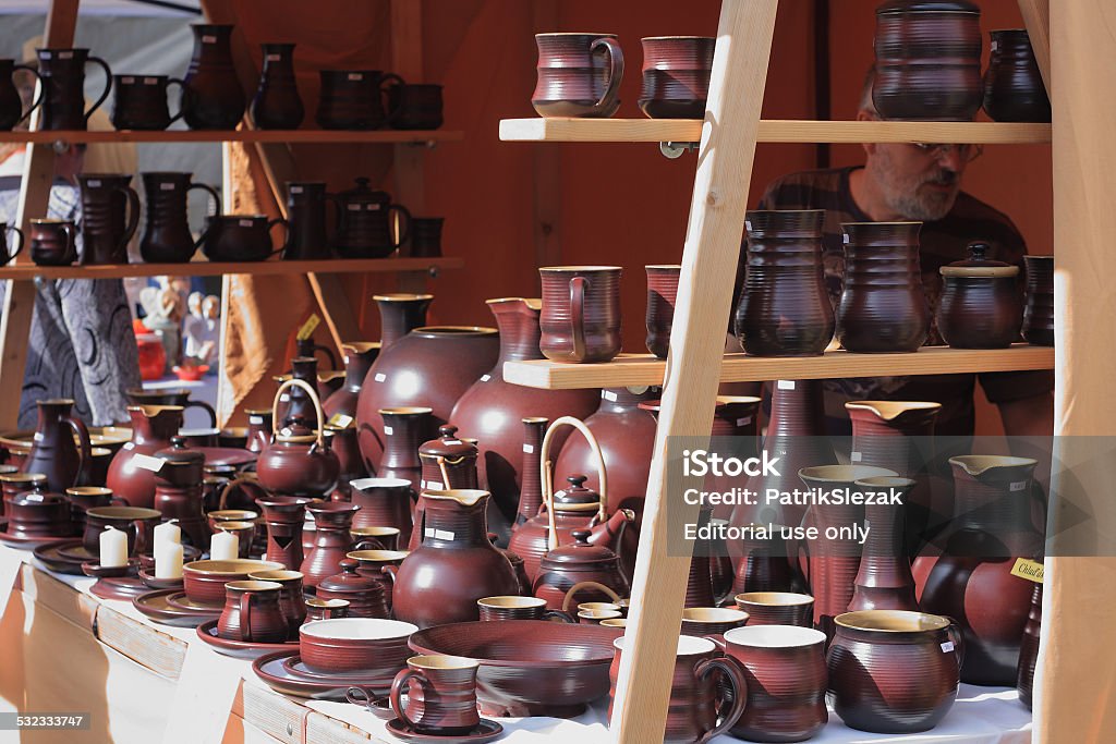 Ttraditional  market with handmade ceramic in Kunstat.  Kunstat,Czech republic-September 20,2014:One of the stands in traditional  market with handmade ceramic in Kunstat. Kunstat is most popular city in Czech Republic , whis is famous for work of ceramic.Man selling your products. 2015 Stock Photo