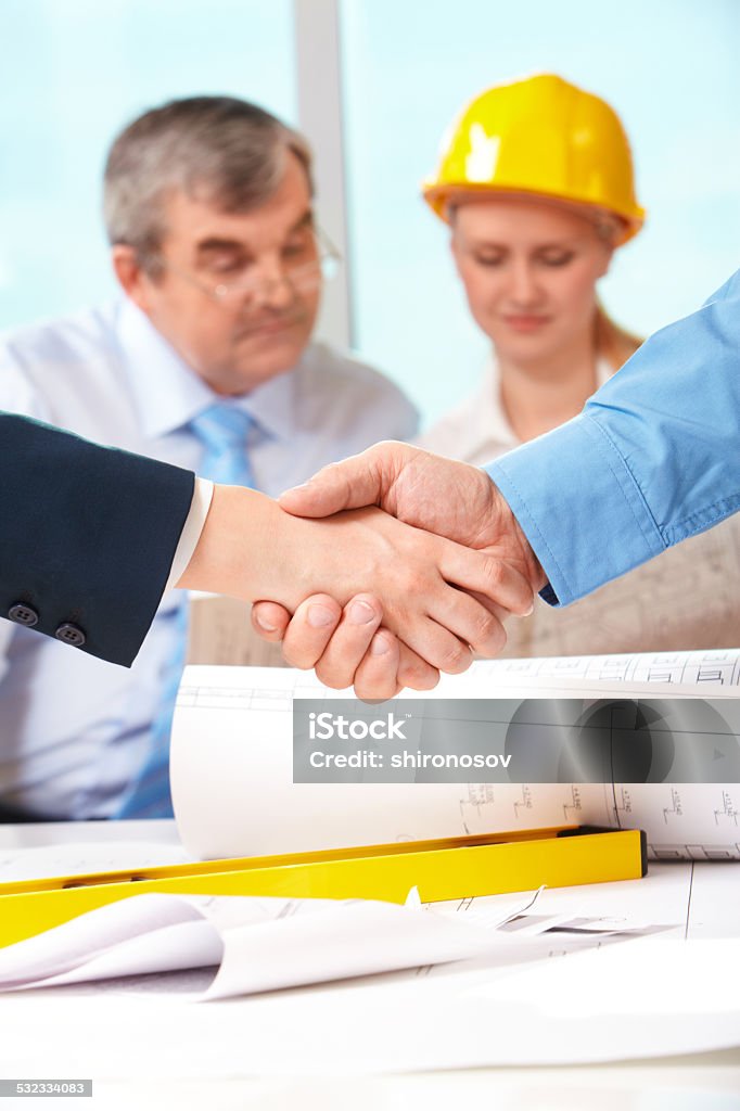 Successful agreement Image of customer and architect handshaking after making an agreement Adult Stock Photo