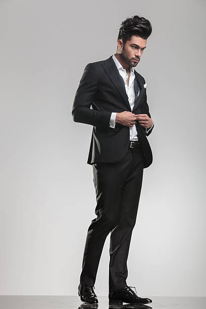 istock Elegant young man in tuxedo closing his jacket 532334269