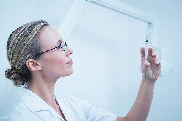 istock Female dentist holding injection 532334611