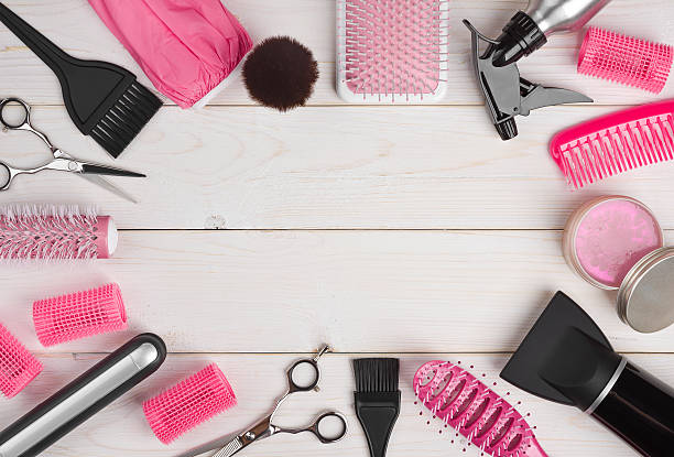 Hairdressing tools on wooden planks background with copyspace in centre