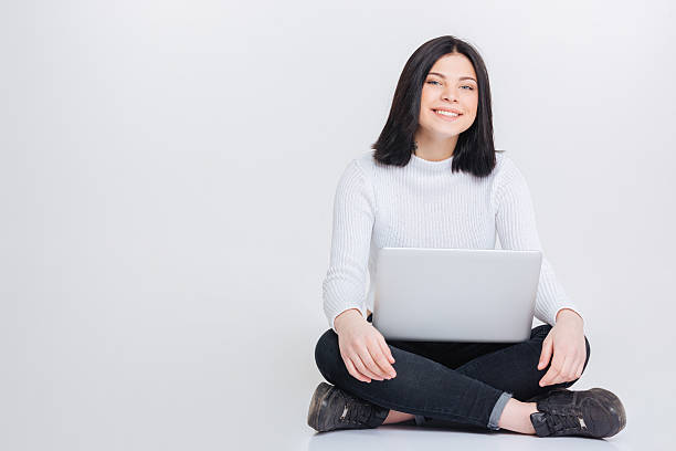 istock Beautiful young woman using laptop 532335422