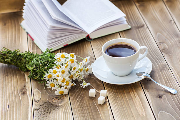 istock Coffee cup with White flower decoration on wooden table 532335580