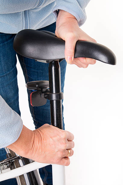 istock Woman sets height of  bicycle saddle before cycling 532335797