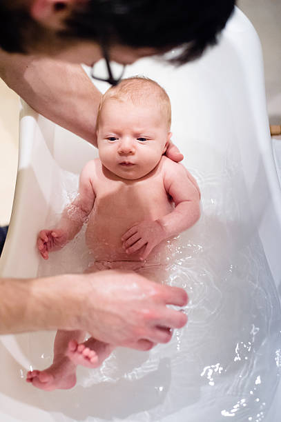 istock Unrecognizable young father bathing his little baby son 532336182