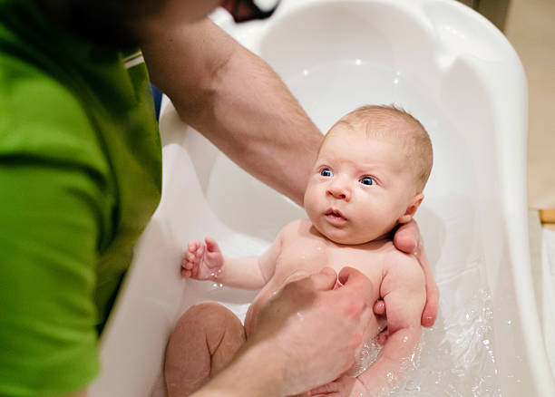istock Unrecognizable young father bathing his little baby son 532336272