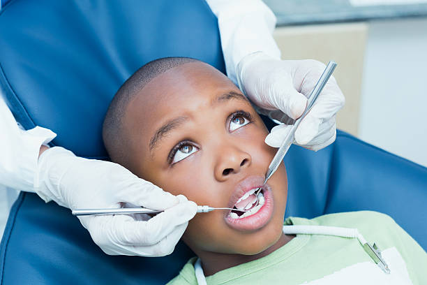 istock Close up of boy having his teeth examined 532336291