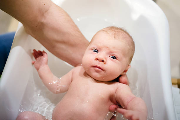 istock Unrecognizable young father bathing his little baby son 532336354
