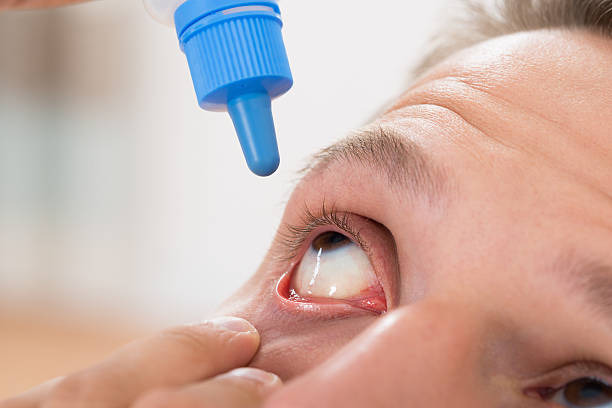 istock Man Pouring Medicine Drops In His Eyes 532336450