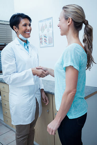 istock Female dentist shaking hands with woman 532336741