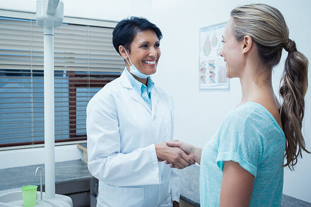 istock Female dentist shaking hands with woman 532336777