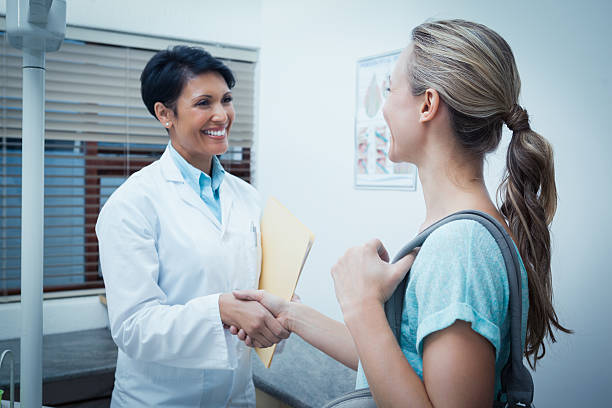 istock Female dentist shaking hands with woman 532336801