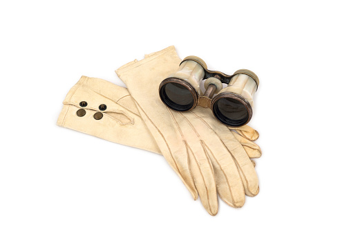 Antique Opera Glasses with Leather Gloves on white background.