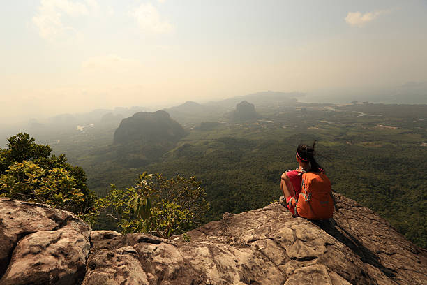istock young woman backpacker hiking on seaside mountain peak 532339558