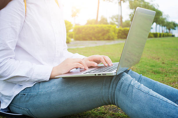 istock Young woman working with laptop in park 532339756