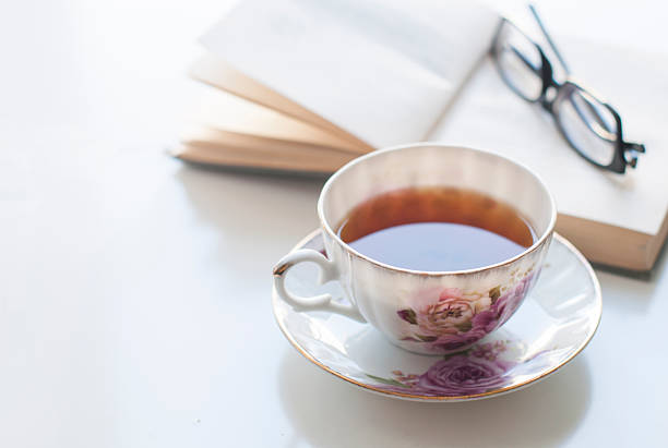 istock Cup of tea, old book and glasses 532342054