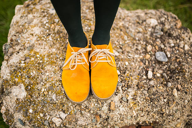 Female Legs With trendy shoes Yellow young Female Legs With trendy shoes yellow shoes stock pictures, royalty-free photos & images