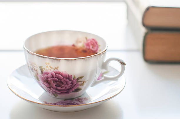 istock China teacup and books on the white table 532343020