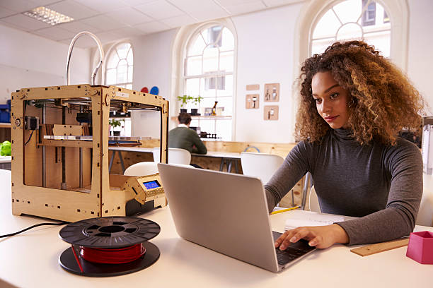 Female Designer Working With 3D Printer In Design Studio Female Designer Working With 3D Printer In Design Studio 3d printing filament photos stock pictures, royalty-free photos & images