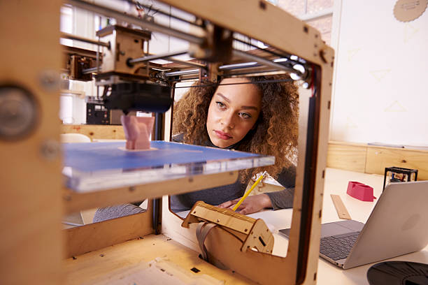 Female Designer Working With 3D Printer In Design Studio Female Designer Working With 3D Printer In Design Studio 3d printing filament photos stock pictures, royalty-free photos & images