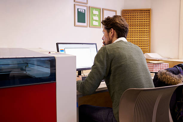 istock Male Designer Operating CAD System For Laser Cutter 532343272