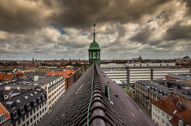 A view from the rooftop garden at the Salling store in Strøget, the main shopping street in Aarhus, a city in Jutland, mainland Denmark. The view includes Aarhus Cathedral (Aarhus Domkirke), part of the city and shoppers walking along Strøget, with a distant view to the harbour.