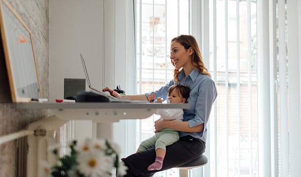 istock Mother Working from home and holding her baby 532343840