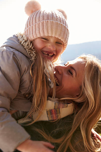 istock Mother lifting her daughter in the air outdoors, vertical 532344244