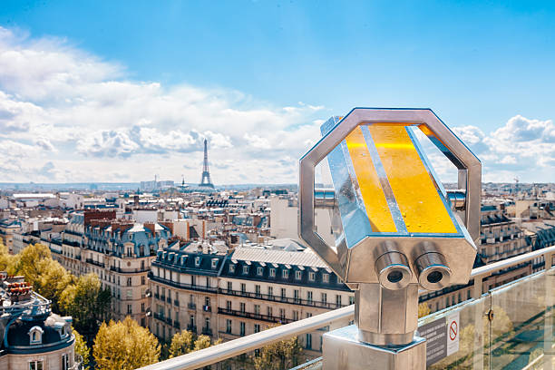 Observation telescope pointed to Eiffel tower / view from the rooftop of the Arc de triomphe, Paris, France