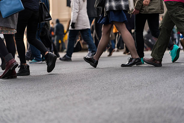 istock Large group of people walking on walkway 532347172
