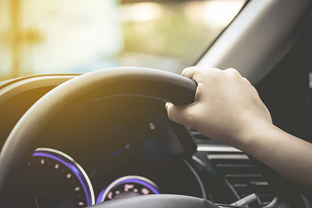 istock female driving car 532347416