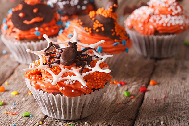 istock Funny colorful Halloween cupcakes on a table close-up. 532348882