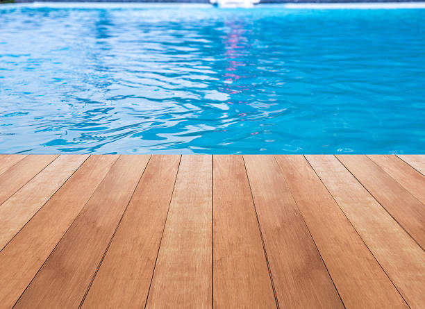 istock Water in swimming pool and wood plank 532351140