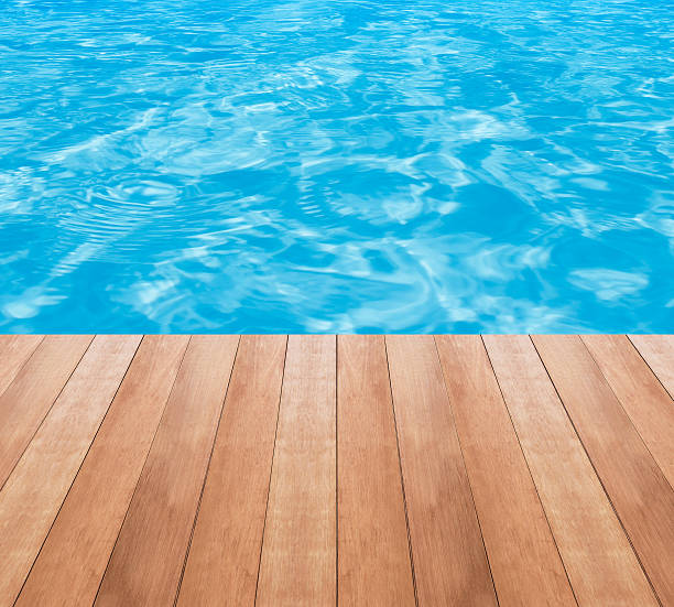 istock Water in swimming pool and wood plank 532351796