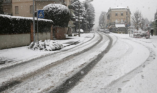istock city street with white snow during a winter snowfall 532351991