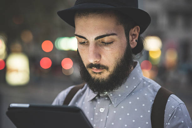 istock young handsome hipster gay modern man using tablet 532352225