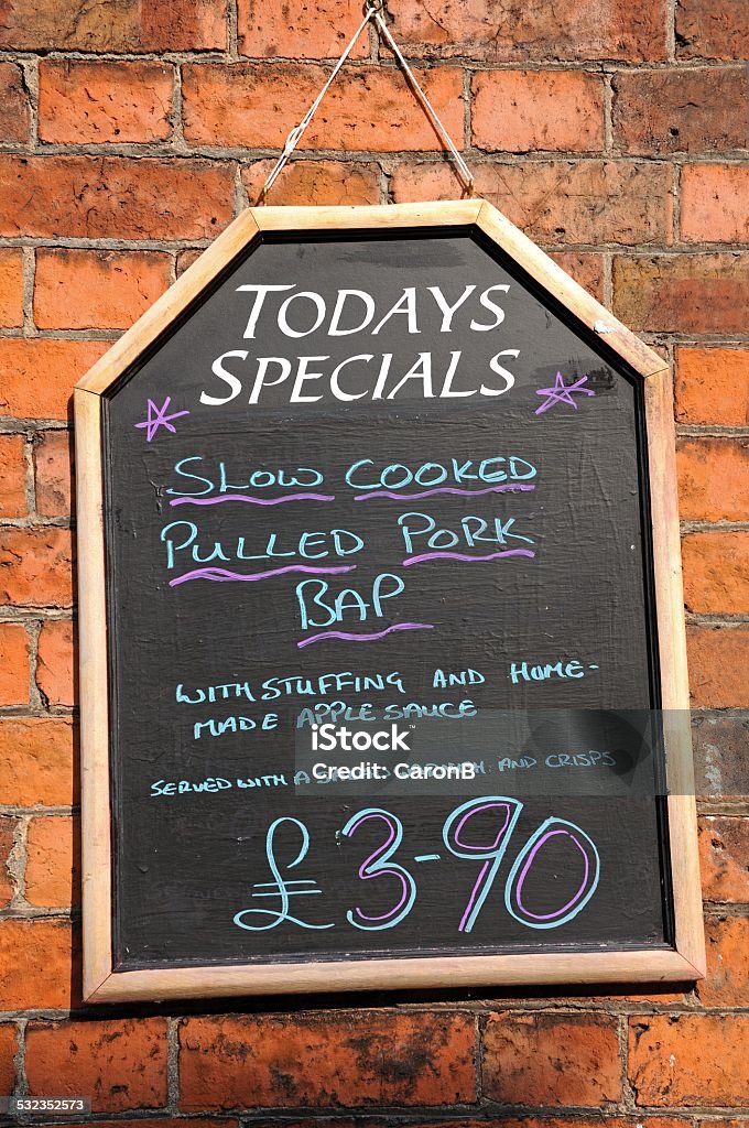 Todays Specials Chalkboard. Todays Special chalkboard against a brick wall advertising Pulled Pork Bap 2015 Stock Photo