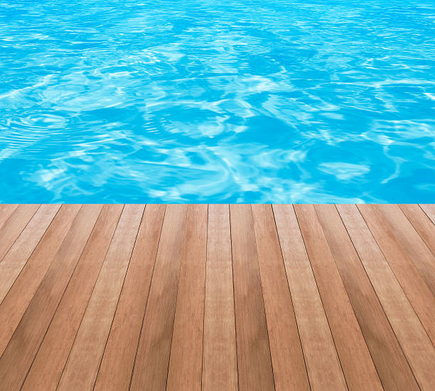 istock Water in swimming pool and wood plank 532352646