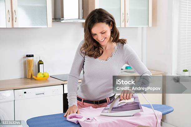 Woman Ironing Cloth With Electric Iron Stock Photo - Download Image Now -  Adult, Clothing, Domestic Kitchen - iStock