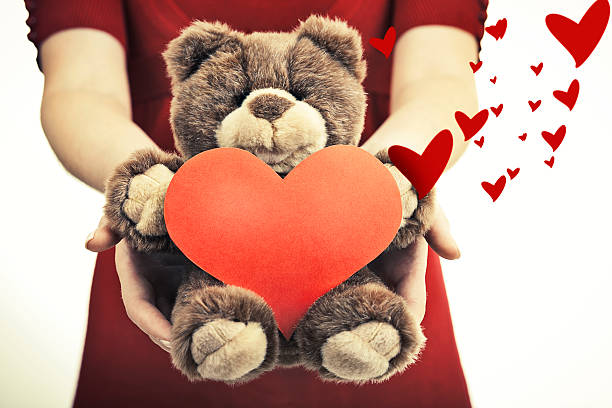 istock Female hands holding magical heart and soft toy. 532353461