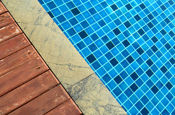 istock Wooden and marble floor beside swimming pool 532354544